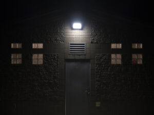 Floodlight illuminating outside of a structure at night on a cold winter day in a park