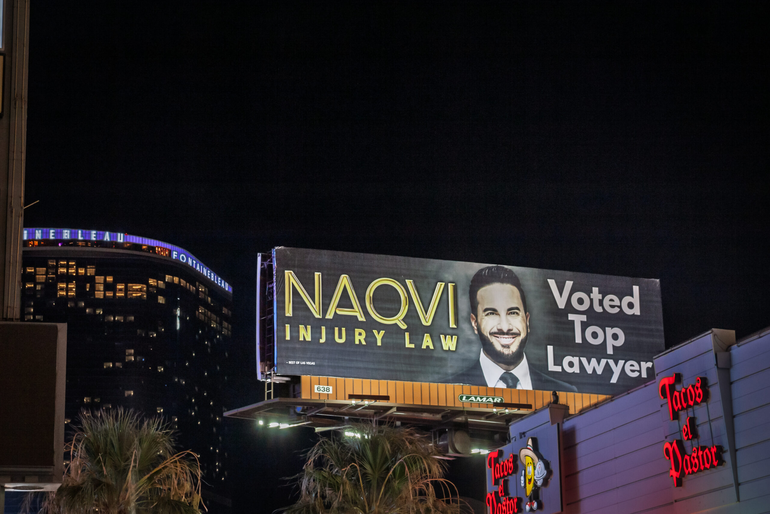 Las Vegas - August 21, 2024: A large illuminated billboard advertises an injury lawyer in Las Vegas. The portrait, bold typography and promise of results convey the style of legal advertising common in U.S. cities. Surrounding lights and high rise silhouettes place the ad in the entertainment corridor where drivers and pedestrians are constant targets for outdoor media. The scene speaks to client outreach, brand recognition, and the competition among personal injury firms, while also reflecting urban marketing practices and the visual noise of the Strip at night.